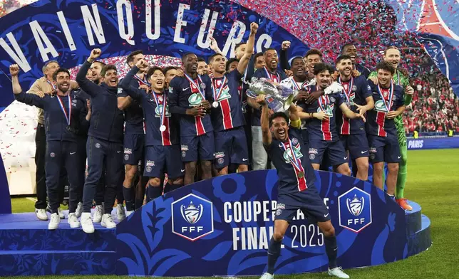 PSG's Marquinhos rises the trophy after winning the French Cup soccer final between Paris Saint-Germain and Reims at the Stade de France stadium in Saint-Denis, outside Paris, Saturday, May 24, 2025. (AP Photo/Aurelien Morissard)