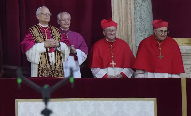 A media drone flies in the foreground as Pope Leo XIV appears on the balcony of St Peter's Basilica after his election, at the Vatican, Thursday, May 8, 2025. (AP Photo/Luca Bruno)