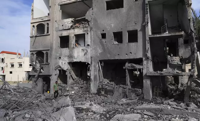 A Palestinian man walks on the rubble of the Al-Zainati family's home, destroyed by Israeli airstrikes in Khan Younis, Gaza Strip, on Thursday, May 15, 2025. (AP Photo/Abdel Kareem Hana)