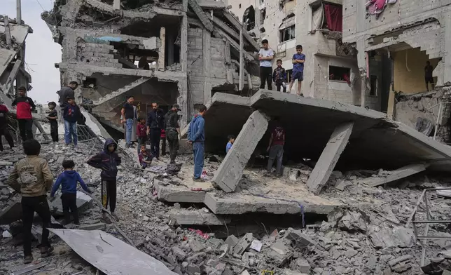 Palestinians inspect the rubble of the Al-Lahham family's home, destroyed by Israeli airstrikes in Khan Younis, Gaza Strip, on Thursday, May 15, 2025. (AP Photo/Abdel Kareem Hana)