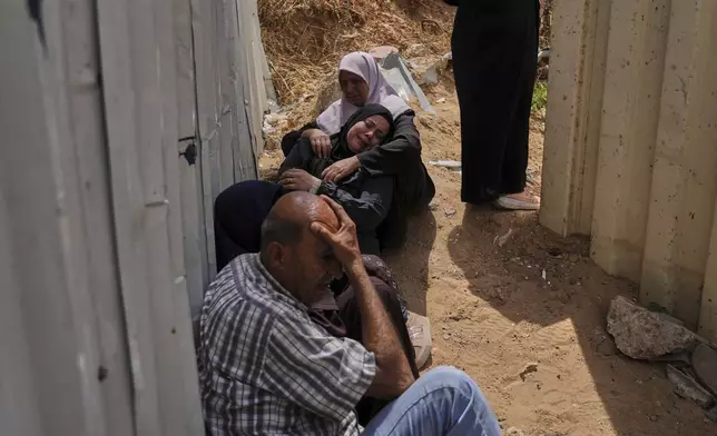 Palestinians mourn their relatives who were killed in Israeli airstrikes on a medical center in Jabalia, northern Gaza Strip, on Thursday, May 15, 2025. (AP Photo/Jehad Alshrafi)