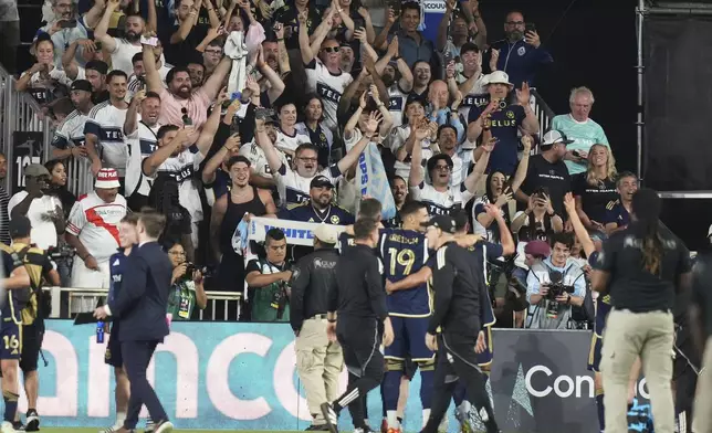 Vancouver Whitecaps fans cheer after a CONCACAF Champions Cup second-leg semifinal soccer match between Inter Miami and the Vancouver Whitecaps, Wednesday, April 30, 2025, in Fort Lauderdale, Fla. (AP Photo/Lynne Sladky)