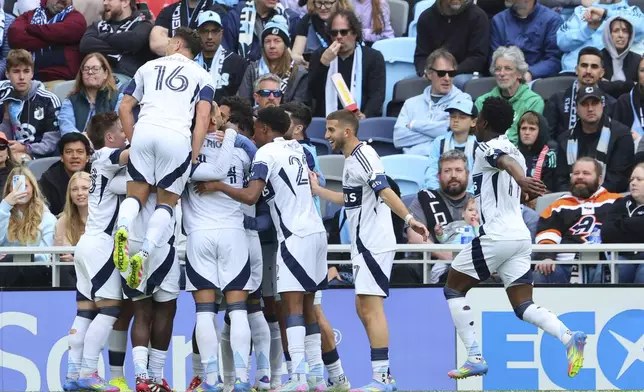 The Vancouver Whitecaps celebrate after a goal by forward Daniel Ríos against Minnesota United during the second half of an MLS soccer match Sunday, April 27, 2025, in St. Paul, Minn. (AP Photo/Adam Bettcher)
