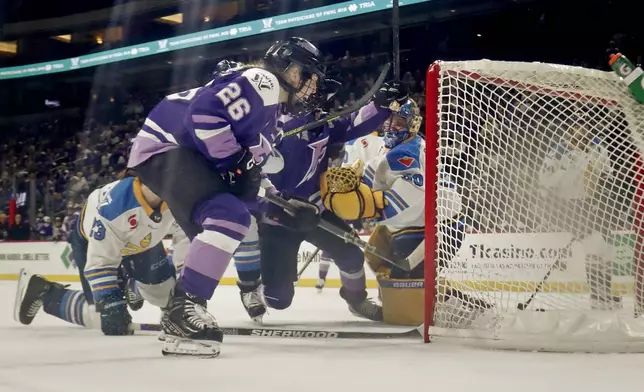 CORRECTS TO GOAL BY FROST'S SOPHIE JAQUES NOT KENDALL COYNE SCHOFIELD - Minnesota Frost forward Kendall Coyne Schofield (26) celebrates after a goal by teammate Sophie Jaques (not shown) against Toronto Sceptres goaltender Kristen Campbell, fourth from left, in the second period of a PWHL hockey playoff game Sunday, May 11, 2025, in St. Paul, Minn. (AP Photo/Bruce Kluckhohn)