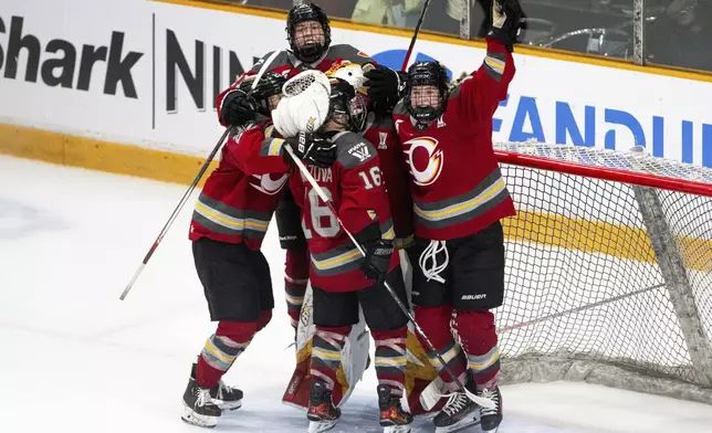Ottawa Charge players celebrate after their win over the Montreal Victoire in PWHL hockey playoff action in Ottawa, Ontario, Friday, May 16, 2025. (Spencer Colby/The Canadian Press via AP)
