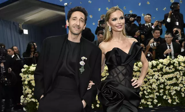 Adrien Brody, left, and Georgina Chapman attend The Metropolitan Museum of Art's Costume Institute benefit gala celebrating the opening of the "Superfine: Tailoring Black Style" exhibition on Monday, May 5, 2025, in New York. (Photo by Evan Agostini/Invision/AP)