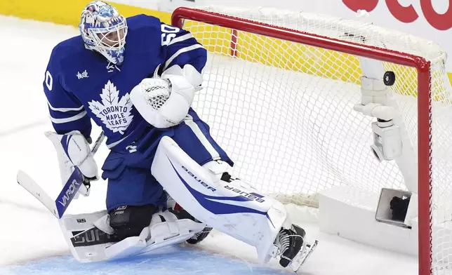 Toronto Maple Leafs goaltender Joseph Woll watches the puck go into the net as the Florida Panthers score during the third period of Game 1 in an NHL hockey second-round playoff series in Toronto, Monday, May 5, 2025. (Frank Gunn/The Canadian Press via AP)