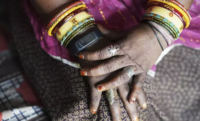 A wristwatch-style health monitor to study how heat affects vulnerable communities is worn by Shantaben Vanzara at her house in Ahmedabad, India, Wednesday, April 2, 2025. (AP Photo/Ajit Solanki)