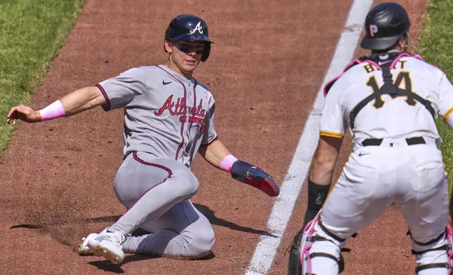 Atlanta Braves' Stuart Fairchild, left, scores the third of three runs on a three-run double by Sean Murphy off Pittsburgh Pirates pitcher Joey Wentz during the eighth inning of a baseball game in Pittsburgh, Sunday, May 11, 2025. (AP Photo/Gene J. Puskar)