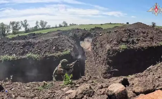 In this photo taken from video distributed by Russian Defense Ministry Press Service on Monday, May 12, 2025, Russian servicemen attend a combat training for assault units in an undisclosed location in Ukraine. (Russian Defense Ministry Press Service via AP)
