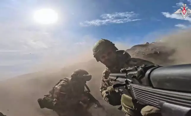 In this photo taken from video distributed by Russian Defense Ministry Press Service on Monday, May 12, 2025, Russian servicemen attend a combat training for assault units in an undisclosed location in Ukraine. (Russian Defense Ministry Press Service via AP)