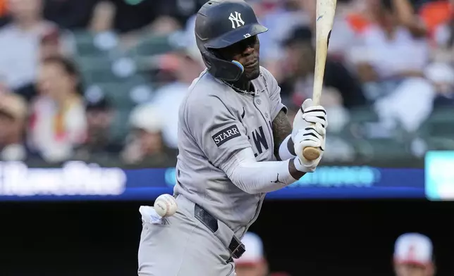 New York Yankees' Jazz Chisholm Jr. is hit by a pitch from Baltimore Orioles starter Tomoyuki Sugano during the first inning of a baseball game, Monday, April 28, 2025, in Baltimore. (AP Photo/Stephanie Scarbrough)