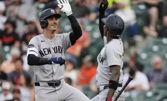 New York Yankees' Cody Bellinger, left, celebrates with Jazz Chisholm Jr. after hitting a home run during the first inning of a baseball game against the Baltimore Orioles, Tuesday, April 29, 2025, in Baltimore. (AP Photo/Stephanie Scarbrough)