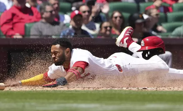 St. Louis Cardinals' Victor Scott II scores during the fifth inning of a baseball game against the Pittsburgh Pirates, Wednesday, May 7, 2025, in St. Louis. (AP Photo/Jeff Roberson)