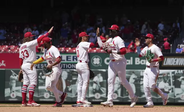 Members of the St. Louis Cardinals celebrate a victory over the Pittsburgh Pirates in a baseball game Wednesday, May 7, 2025, in St. Louis. (AP Photo/Jeff Roberson)
