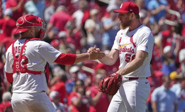 St. Louis Cardinals' Chris Roycroft, right, and Pedro Pages celebrate a victory over the Pittsburgh Pirates in a baseball game Wednesday, May 7, 2025, in St. Louis. (AP Photo/Jeff Roberson)