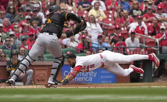 St. Louis Cardinals' Victor Scott II (11) scores past Pittsburgh Pirates catcher Joey Bart during the third inning of a baseball game Wednesday, May 7, 2025, in St. Louis. (AP Photo/Jeff Roberson)