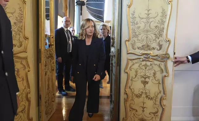 Italy's Prime Minister Giorgia Meloni, center, and European Commission President Ursula von der Leyen, center right, arrive for a meeting with Vice President JD Vance at the Chigi Palace in Rome, Italy, Sunday, May 18, 2025. (AP Photo/Jacquelyn Martin, Pool)