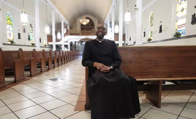 Reverend Ajani K. Gibson, pastor of St. Peter Claver, a Catholic Church in the 7th Ward neighborhood where the grandparents of Pope Leo XIV lived, speaks with The Associated Press inside the Church in New Orleans, Friday, May 9, 2025. (AP Photo/Gerald Herbert)