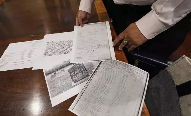 Jari Honora, family historian for the Historic New Orleans Collection, shows genealogy material of the grandparents of Pope Leo XIV in New Orleans, Friday, May 9, 2025. (AP Photo/Gerald Herbert)