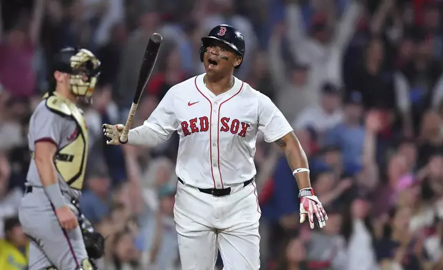 Boston Red Sox's Rafael Devers, right, reacts as he starts to run the bases after hitting a walkoff home run in the ninth inning of a baseball game against the Atlanta Braves, Saturday, May 17, 2025, in Boston. (AP Photo/Steven Senne)