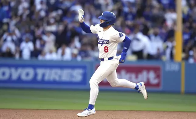 Los Angeles Dodgers' Kiké Hernández gestures as he heads to second after hitting a solo home run during the fourth inning of a baseball game against the Los Angeles Angels, Saturday, May 17, 2025, in Los Angeles. (AP Photo/Mark J. Terrill)