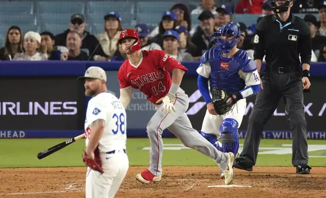 Los Angeles Angels' Logan O'Hoppe, second from left, heads to first for a three-run home run as Los Angeles Dodgers relief pitcher Kirby Yates, left, and catcher Dalton Rushing watches during the seventh inning of a baseball game Saturday, May 17, 2025, in Los Angeles. (AP Photo/Mark J. Terrill)