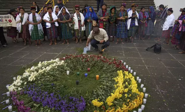 Indigenous women stand next to an altar they created outside the Supreme Court as they wait for an expected ruling, by a different court, in a case against three former paramilitary fighters who were trained by the military and are accused of raping 36 women four decades ago during Guatemala's civil war, in Guatemala City, Friday, May 30, 2025. (AP Photo/Moises Castillo)