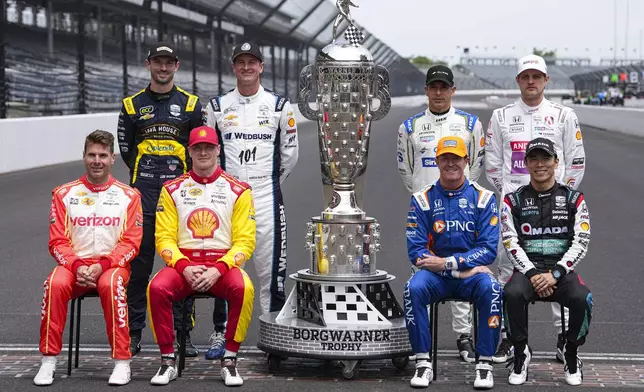 The former winners of the Indianapolis 500, top row, left to right, Alexander Rossi, Ryan Hunter-Reay, Helio Castroneves, of Brazil, and Marcus Ericsson, of Sweden, bottom bottom row, Will Power, of Australia, Josef Newgarden, Scott Dixon, of New Zealand, and Takuma Sato, of Japan, pose for a photo on the start/finish line before practice for the Indianapolis 500 auto race at the Indianapolis Motor Speedway in Indianapolis, Monday, May 19, 2025. (AP Photo/Michael Conroy)