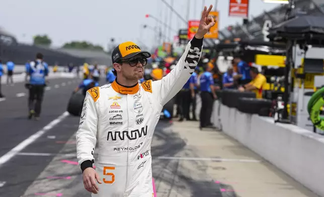 Pato O'Ward, of Mexico, waves to fans before the start of practice for the Indianapolis 500 auto race at the Indianapolis Motor Speedway in Indianapolis, Monday, May 19, 2025. (AP Photo/Michael Conroy)