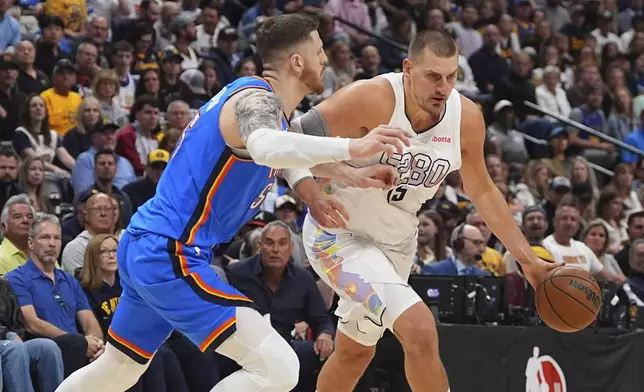 Denver Nuggets center Nikola Jokic, right, drives past Oklahoma City Thunder center Isaiah Hartenstein in the first half of Game 6 in the Western Conference semifinals of the NBA basketball playoffs Thursday, May 15, 2025, in Denver. (AP Photo/David Zalubowski)