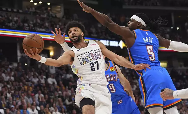 Denver Nuggets guard Jamal Murray, front left, drives to the basket as Oklahoma City Thunder guards Alex Caruso, back left, and Luguentz Dort defend in the first half of Game 6 in the Western Conference semifinals of the NBA basketball playoffs Thursday, May 15, 2025, in Denver. (AP Photo/David Zalubowski)