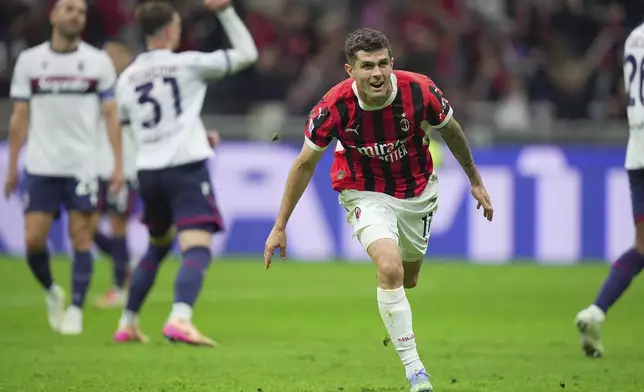 AC Milan's Christian Pulisic celebrates after scoring their second goal of the game during the Serie A soccer match between Milan and Bologna at San Siro Stadium in Milan, Italy, Friday May 9, 2025. (Spada/LaPresse via AP)