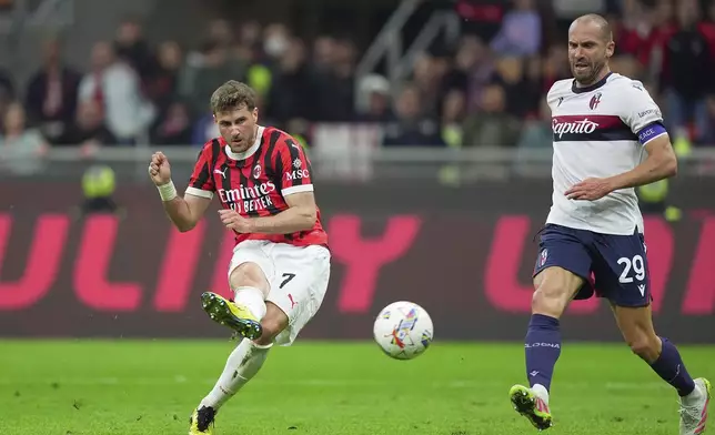 AC Milan's Santiago Gimenez scores their third goal of the game during the Serie A soccer match between Milan and Bologna at San Siro Stadium in Milan, Italy, Friday May 9, 2025. (Spada/LaPresse via AP)