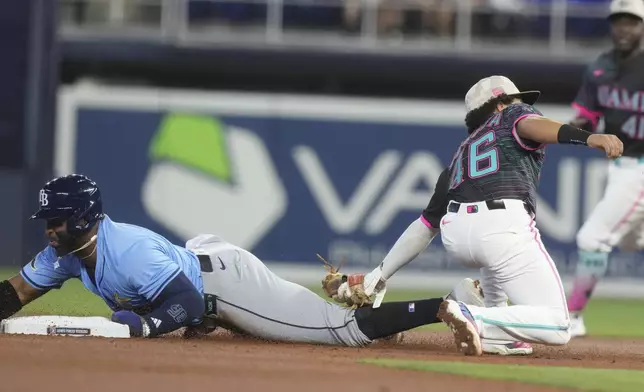 Tampa Bay Rays' Yandy Díaz (2) as Miami Marlins short stop Javier Sanoja (46) is late with the tags during the first inning of a baseball game, Saturday, May 17, 2025, in Miami. (AP Photo/Marta Lavandier)