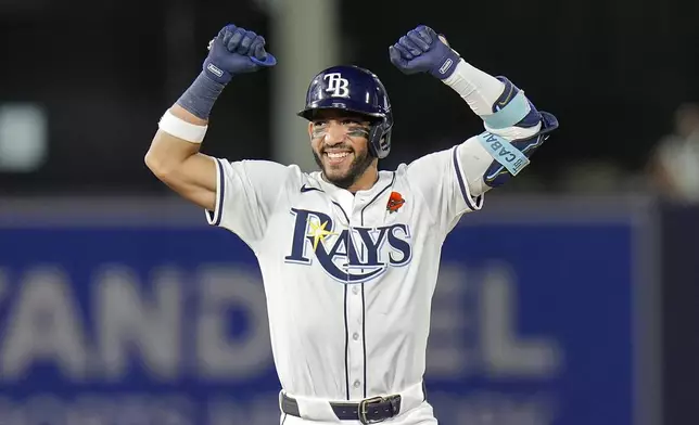 Tampa Bay Rays' José Caballero celebrates his two-run double off Minnesota Twins pitcher Kody Funderburk during the eighth inning of a baseball game Monday, May 26, 2025, in Tampa, Fla. (AP Photo/Chris O'Meara)