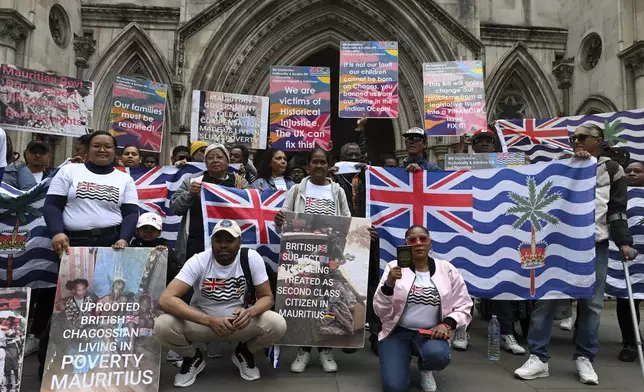People demonstrate outside the High Court in London, Thursday, May 22, 2025, after a British court blocked the U.K. from transferring sovereignty over the Chagos Islands to Mauritius hours before the agreement was due to be signed. (AP Photo/Thomas Krych)