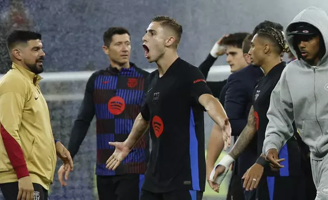 Barcelona's Fermin Lopez celebrates at the end of the Spanish La Liga soccer match between Barcelona and Espanyol at Lluis Companys Olympic Stadium in Barcelona, Spain, Thursday, May 15, 2025. (AP Photo/Joan Monfort)