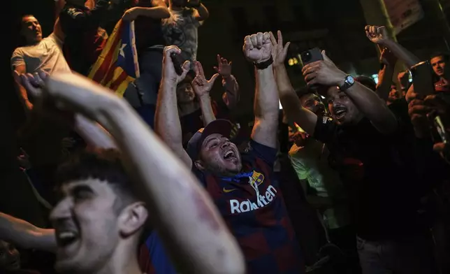Barcelona fans celebrate in the street after their team won the Spanish La Liga soccer championship in Barcelona, Spain, Thursday, May 15, 2025. (AP Photo/Emilio Morenatti)