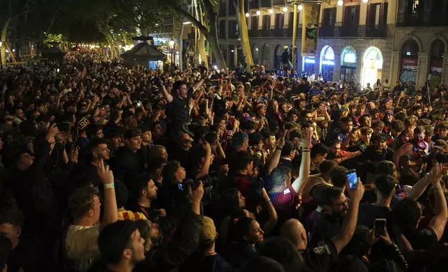 Barcelona fans celebrate in the street after their team won the Spanish La Liga soccer championship in Barcelona, Spain, Thursday, May 15, 2025. (AP Photo/Emilio Morenatti)