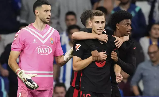 Barcelona's Fermin Lopez, center, reacts after scoring during a Spanish La Liga soccer match between Espanyol and Barcelona in Barcelona, Spain, Thursday, May 15, 2025. (AP Photo/Jose Breton)