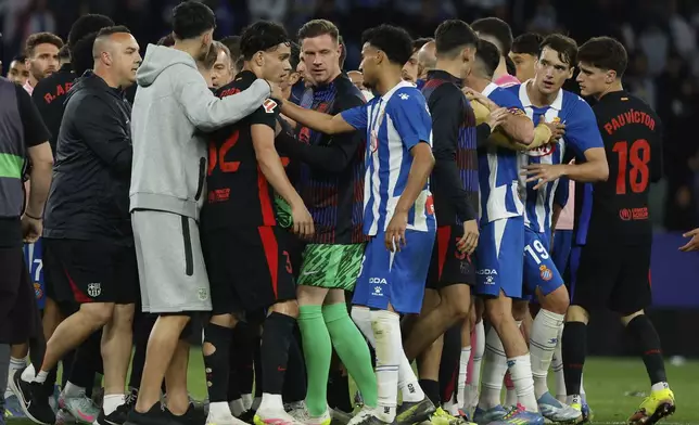 Barcelona players scuffle with Espanyol players at the end of the Spanish La Liga soccer match between Barcelona and Espanyol at Lluis Companys Olympic Stadium in Barcelona, Spain, Thursday, May 15, 2025. (AP Photo/Joan Monfort)