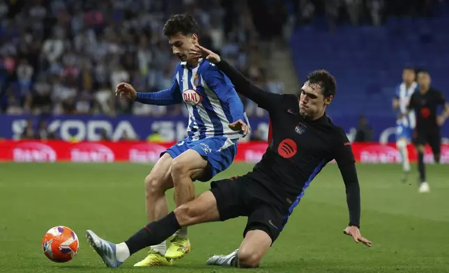 Espanyol's Antoniu Roca, left, fights for the ball with Barcelona's Andreas Christensen during a Spanish La Liga soccer match between Barcelona and Espanyol at Lluis Companys Olympic Stadium in Barcelona, Spain, Thursday, May 15, 2025. (AP Photo/Joan Monfort)