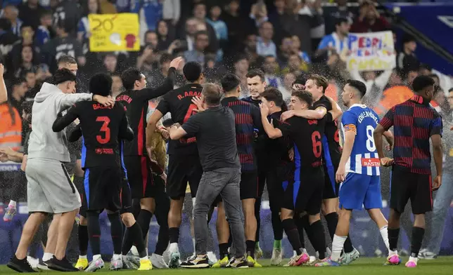 Barcelona players celebrate becoming champions after Spanish La Liga soccer match between Espanyol and Barcelona in Barcelona, Spain, Thursday, May 15, 2025. (AP Photo/Jose Breton)