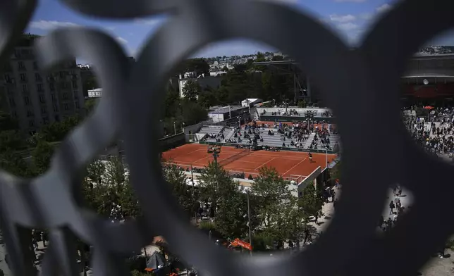 Visitors watch matchs before the draw of French Open tennis tournament Thursday, May 22, 2025 at the Roland Garros stadium in Paris. (AP Photo/Christophe Ena)