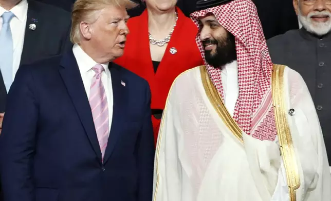 President Donald Trump, left, speaks with Saudi Arabia's Crown Prince Mohammed bin Salman during family photo session at G-20 leaders summit in Osaka, Japan, June 28, 2019. (Kim Kyung-Hoon/Pool Photo via AP, File)