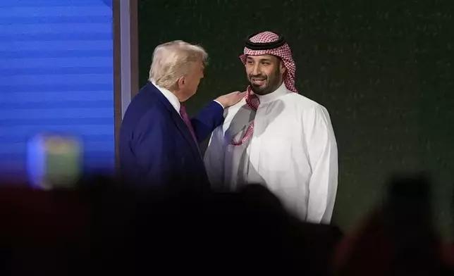 President Donald Trump shakes hands with Saudi Crown Prince Mohammed bin Salman after his speech at the King Abdulaziz International Conference Center in Riyadh, Saudi Arabia, Tuesday, May 13, 2025. (AP Photo/Alex Brandon)