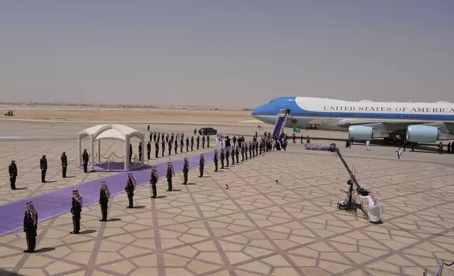 President Donald Trump walks with Saudi Crown Prince Mohammed bin Salman during an arrival ceremony at the Royal Terminal of King Khalid International Airport in Riyadh, Saudi Arabia, Tuesday, May 13, 2025