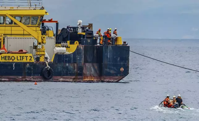 The multi-purpose floating work barge Hebo Lift 2 monitors the stretch of sea off Porticello, near Palermo, Sicily, Italy, Sunday, May 4, 2025, where the British superyacht Bayesian sunk on August 19, 2024 as the operations for its recovery start. (AP Photo/Salvatore Cavalli)