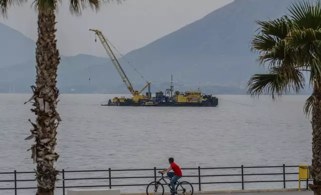 The multi-purpose floating work barge Hebo Lift 2 monitors the stretch of sea off Porticello, near Palermo, Sicily, Italy, Sunday, May 4, 2025, where the British superyacht Bayesian sunk on August 19, 2024 as the operations for its recovery start. (AP Photo/Salvatore Cavalli)
